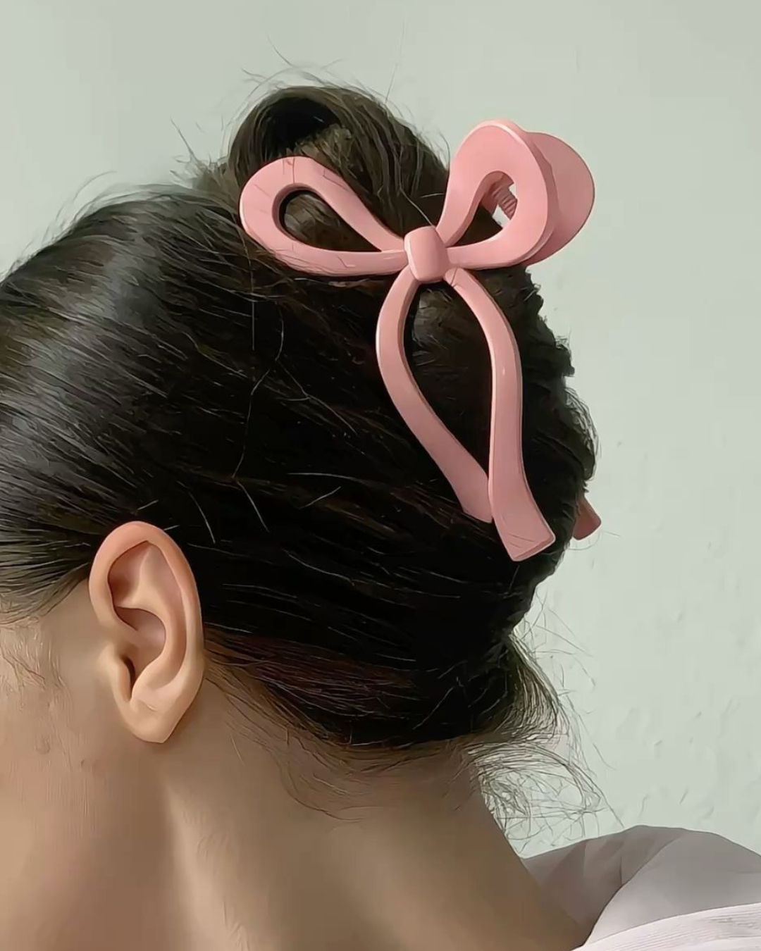 Woman wearing pink korean bow claw clip hairstyle accessory