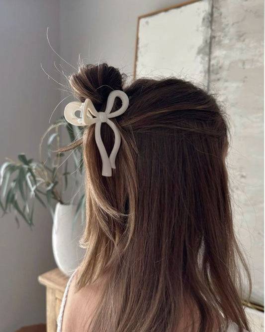 Woman wearing small korean bow claw clip hairstyle accessory